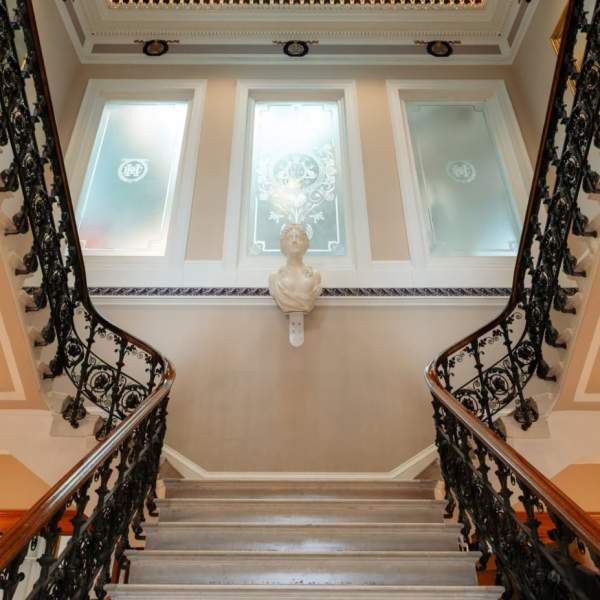Inside the Hull Maritime Museum. Looking upwards towards the stairs balcony with a statue bust in the centre.