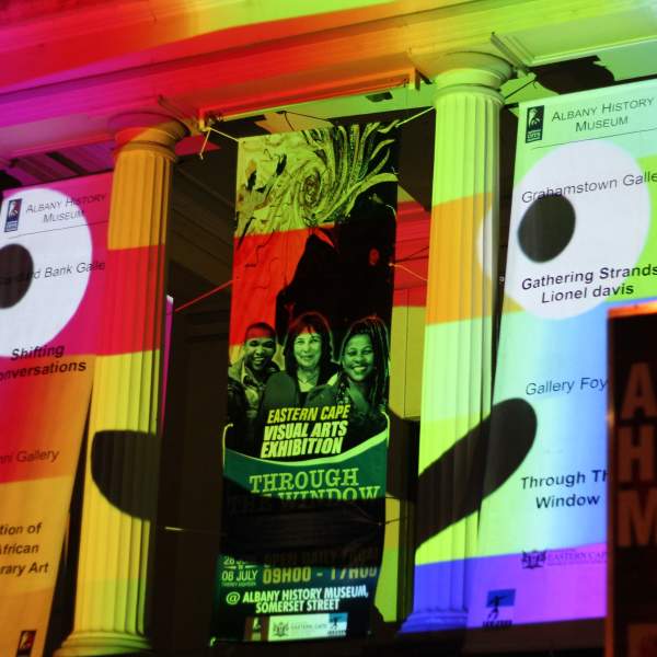 A building with pillars projected with a smiling face