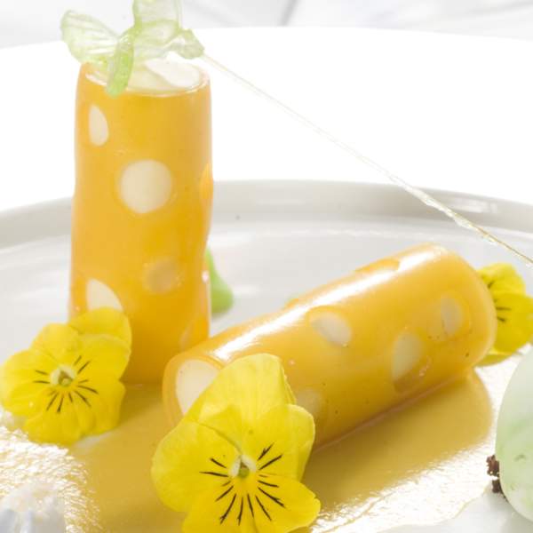 A yellow dessert on a white plate