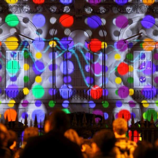 The Senate House, Cambridge light up with a digital projection in bright spotlights