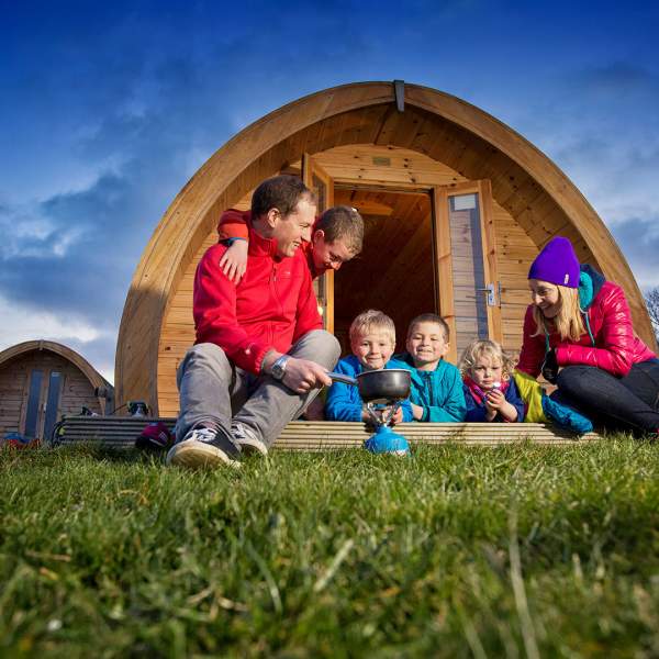Family Glamping at Cushendall outside their pod in the evening time