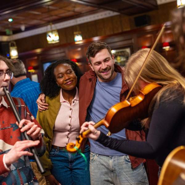 Group of musicians playing traditional Irish instruments in The Dark Horse in Belfast.
