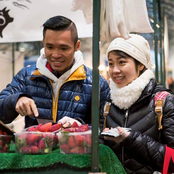 International visitors sampling the fruit stalls at St George's Market.
