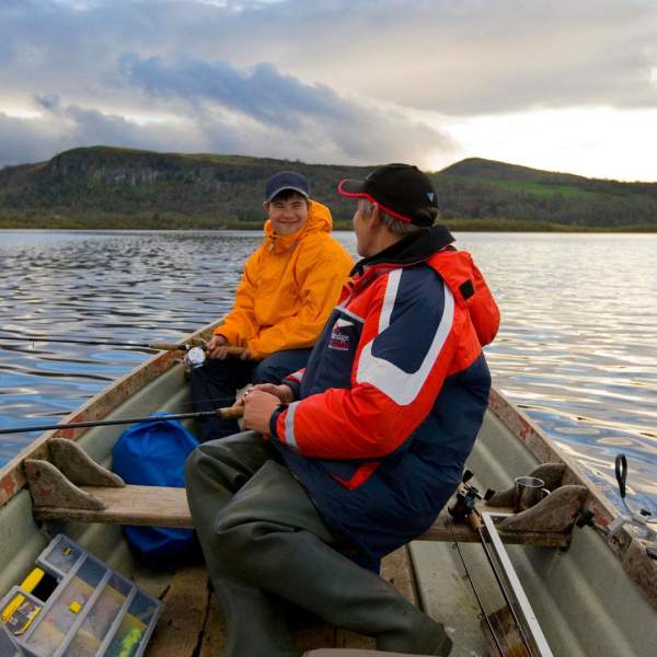 Father and son fishing on a row boat on Lough Macnean in Fermanagh