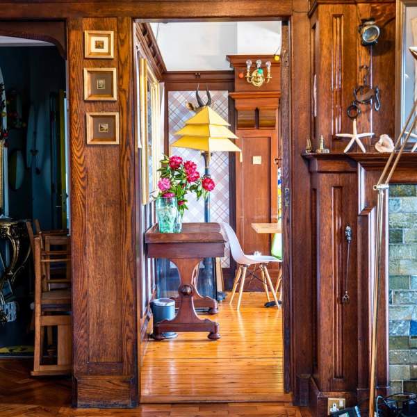 A beautifully decorated hallway can be seen, along with a glimpse of a living room in Cairn Bay Lodge