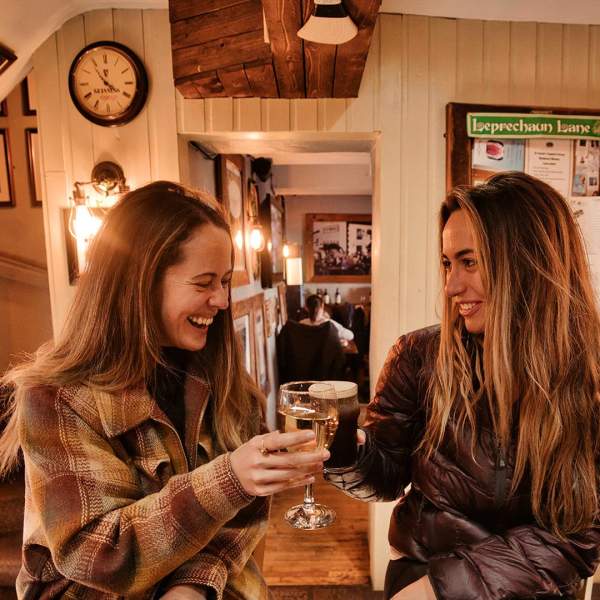 2 girls enjoying a drink in Mary McBride's in Cushendun