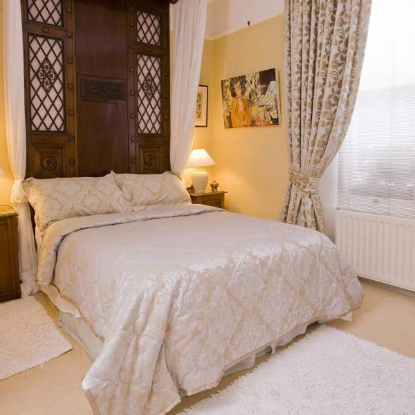 a made up bed at Laurel Villa Guest House