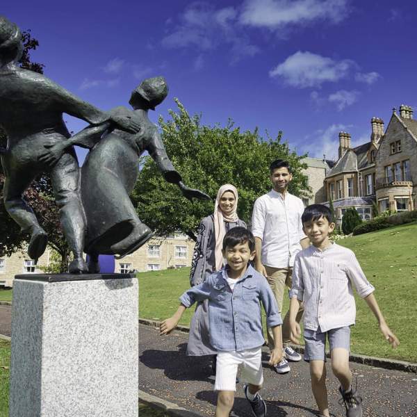 Family has fun exploring the grounds of the Culloden Hotel on a sunny day