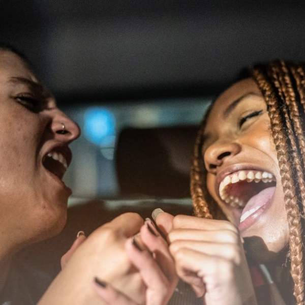 Two women singing at a live concert in Orlando.