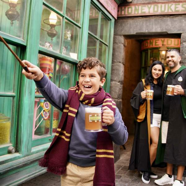 Family enjoying Butterbeer in The Wizarding World of Harry Potter at Universal Orlando Resort