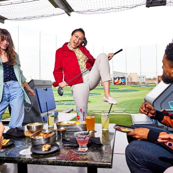 Woman celebrating shot at Topgolf