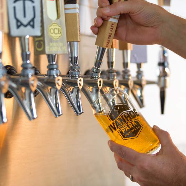 A bartender pours a draft beer at Ivanhoe Park Brewing Company in Orlando.