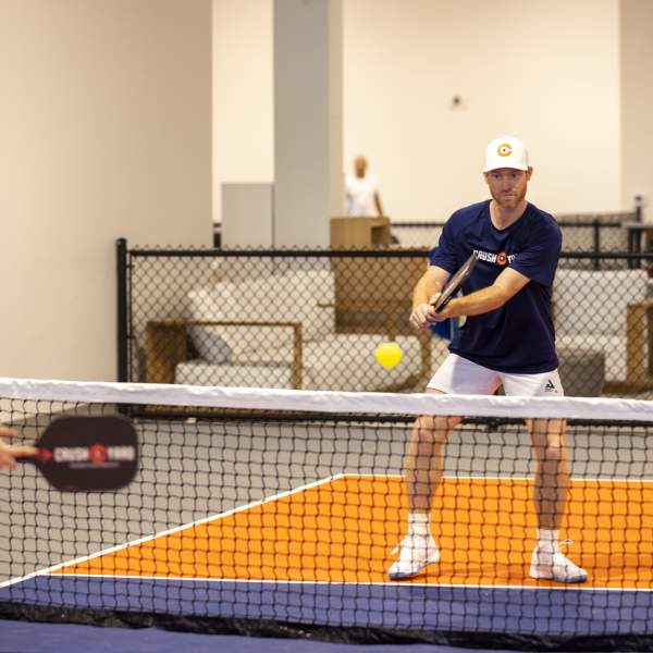 Anna Cooke, director of marketing, faces off against Evan Addington, director of pickleball, at Crush Yard Orlando, a 48,000-square-foot facility that recently opened in Kissimmee on Jan. 14, 2025. (Patrick Connolly/Orlando Sentinel)