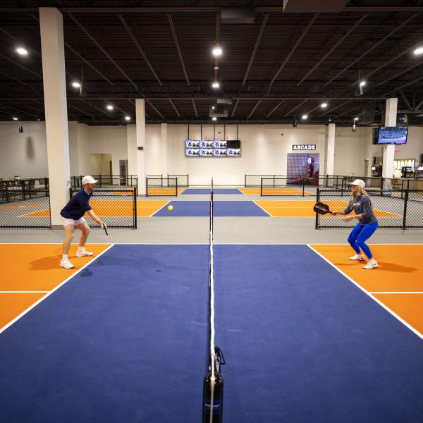 Anna Cooke, director of marketing, faces off against Evan Addington, director of pickleball, at Crush Yard Orlando, a 48,000-square-foot facility that recently opened in Kissimmee on Jan. 14, 2025. (Patrick Connolly/Orlando Sentinel)