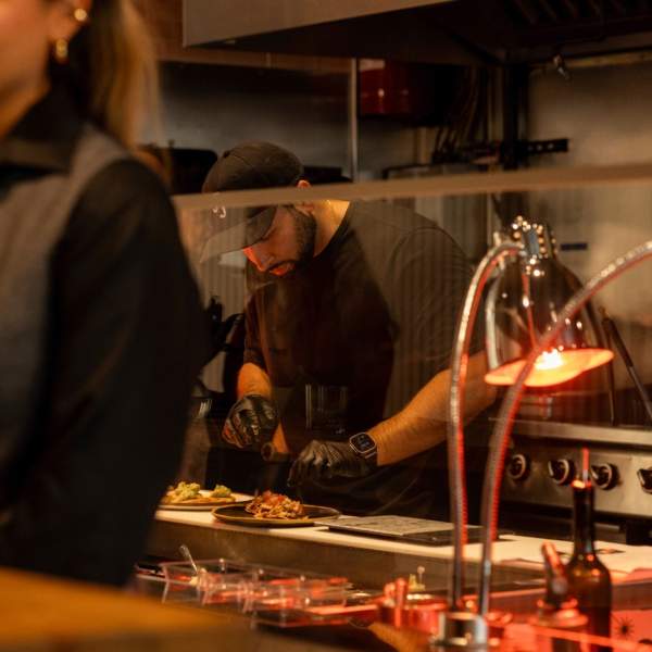 A chef spotted in the kitchen, artfully plating a dish