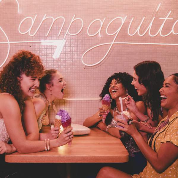 A group of ladies sitting at a booth, laughing and eating ice cream at Sampaguita Ice Cream