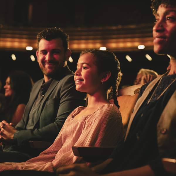 A father and daughter enjoy a show at Steinmetz theater