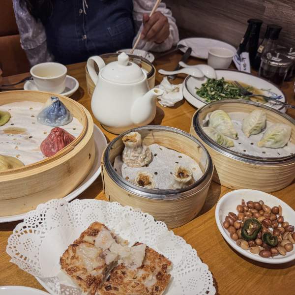 Tabletop spread of several dumpling dishes at One Stop Dumpling