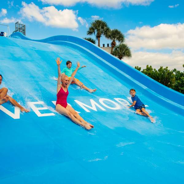 Family Sliding into Pool
