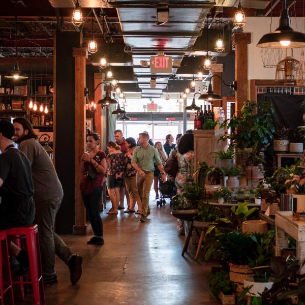 People dining and walking through East End Market in Audubon Park Garden District, an Orlando Main Street.