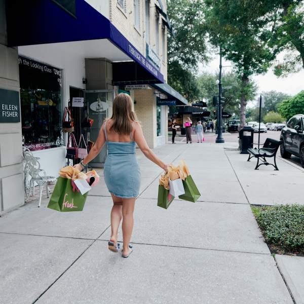A woman holding shopping bags from Frank store in Winter Park