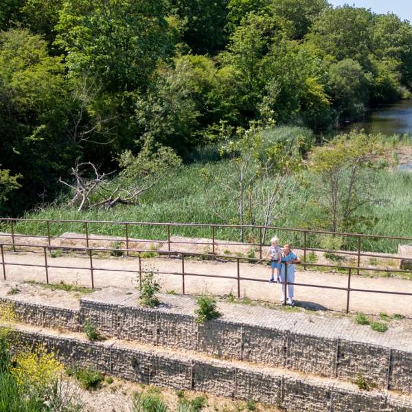 A grandparent and grandchild on a bridge at Hilsea Lines