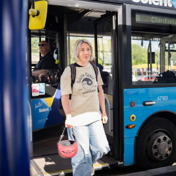 A lady gets off the bus at Hilsea Lines