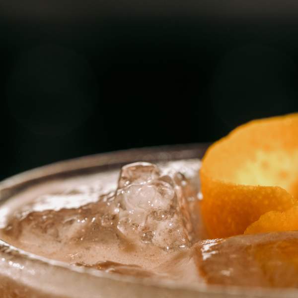 Close up view of drink with orange rind