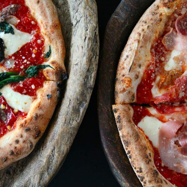 Overhead view of two pizzas side by side.