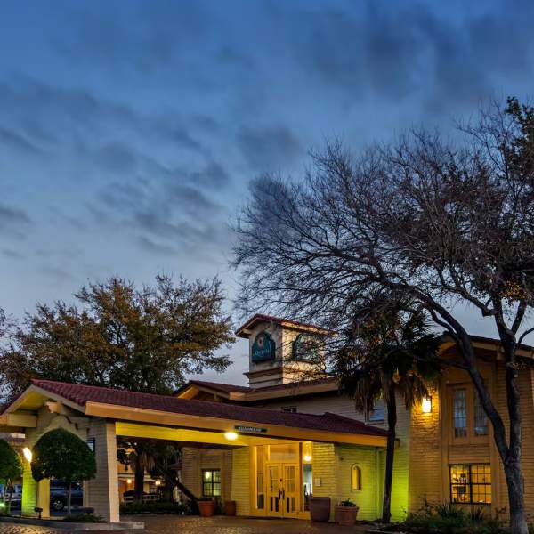 Exterior view of hotel at dusk with ambient lighting