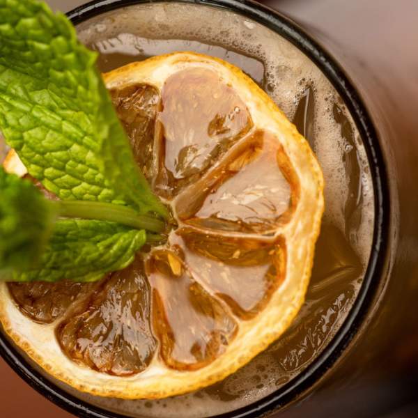 Adult beverage with greenery as garnish