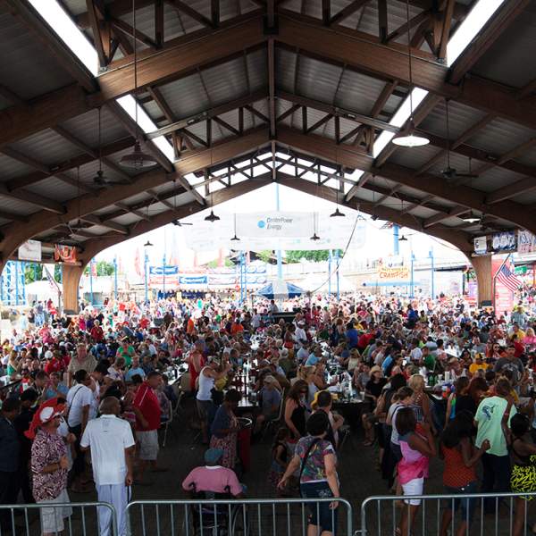 Crowd at annual Mudbug Madness Festival under pavilion, at Festival Plaza in downtown Shreveport