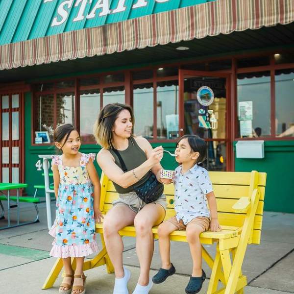 Photo of a Family Eating snowcones outside of Streetcar Station