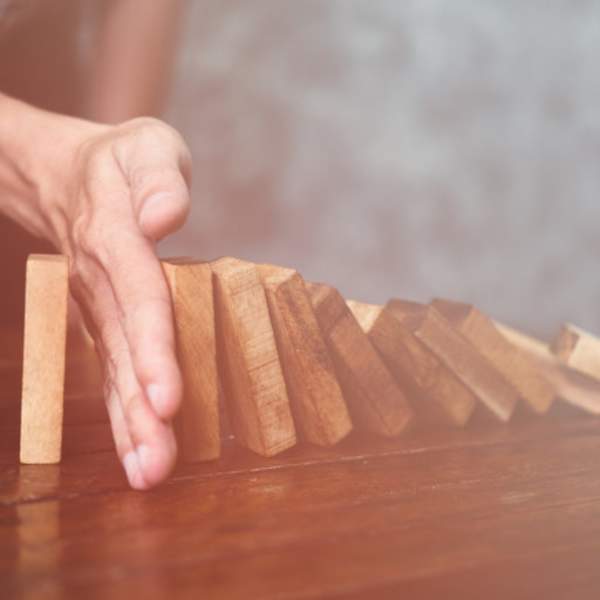 hand blocking dominoes