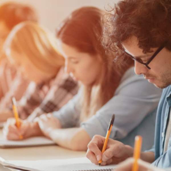 people writing at table