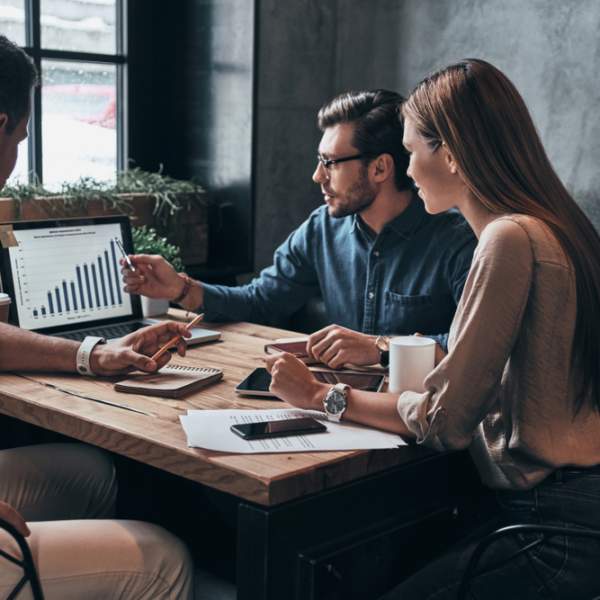 people at table looking at laptop