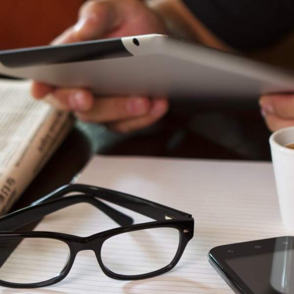 person using tablet at table