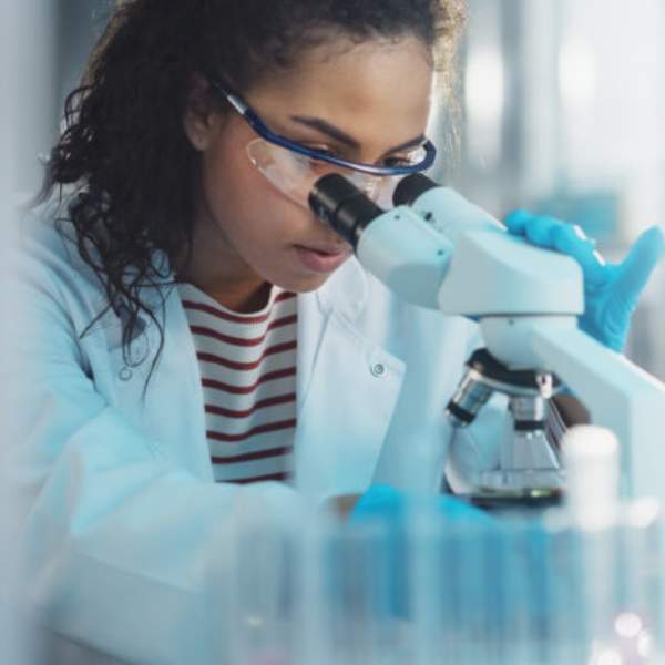 Person Using Microscope