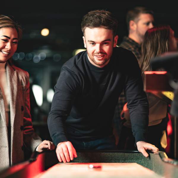 Man and woman playing shuffleboard at CRIB