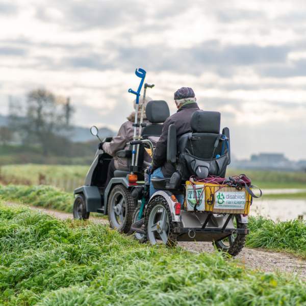 Two electric scooters traversing a path in the South downs national park