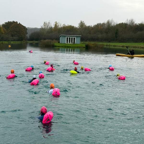 Group of people swimming in a lake