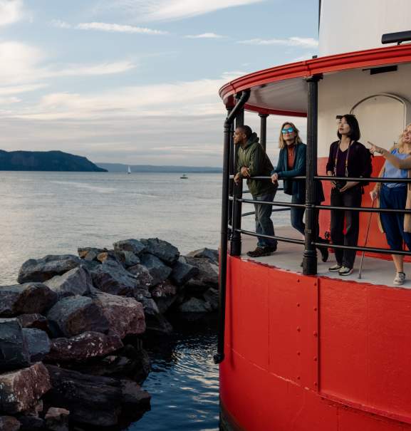 people looking out from a lighthouse platform