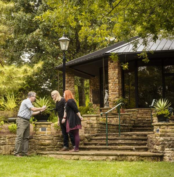 Three people outside Baker Arboretum