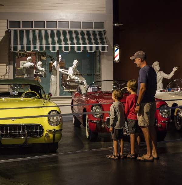 A father and sons look at cars at the National Corvette Museum in Bowling Green, KY