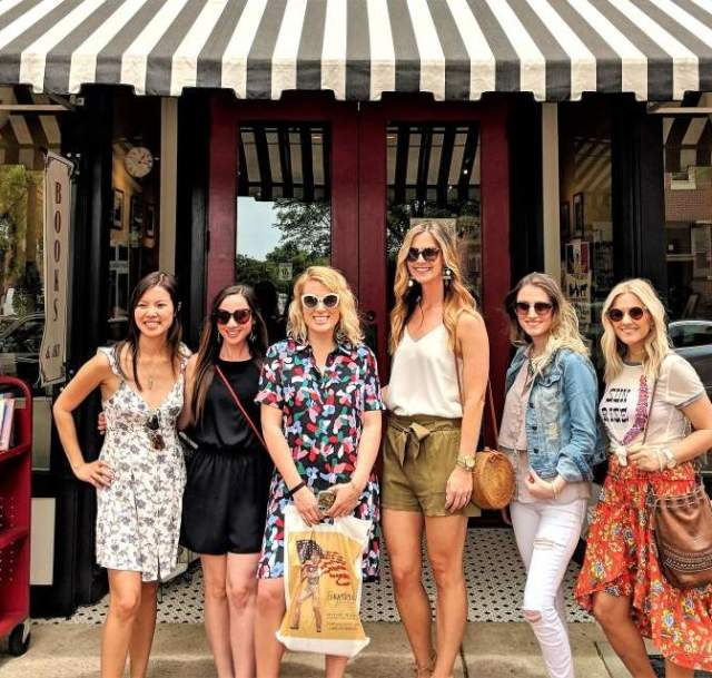 Group of women standing in front of City Center Gallery & Books in downtown Fayetteville, NC, a local bookstore and art gallery.