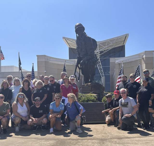 Military reunion group gathered in front of the Airborne & Special Operations Museum statue in Fayetteville, North Carolina