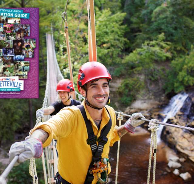 Men enjoying a day at Cumberland County's ZipQuest with the cover of the Greater Fayetteville Digital Destination Guide