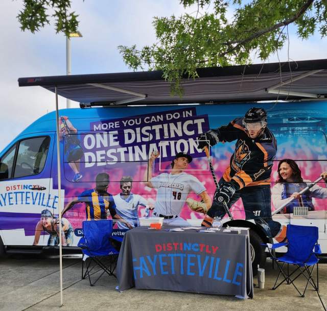 DistiNCtly Fayetteville MIC van and event booth set up outside the Airborne & Special Operations Museum, promoting local attractions and community engagement.