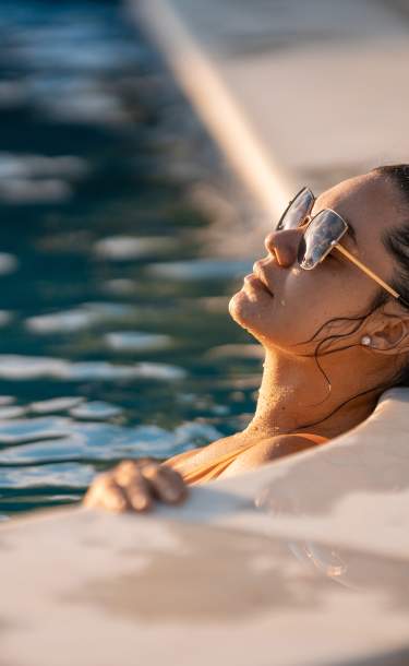 Woman relaxing in San Diego pool