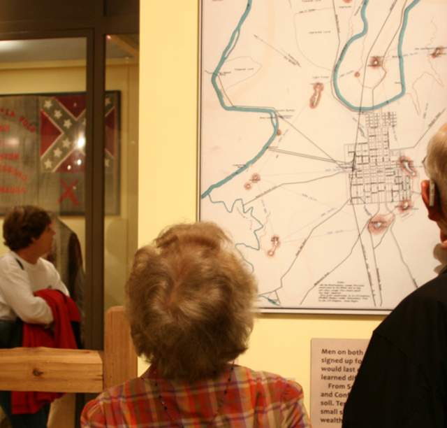 Visitors examine a map hung as part of the Civil War Exhibit at the Kentucky Museum